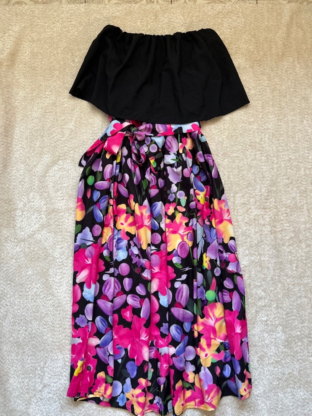 Strapless floral dress features a solid black ruffled overlay top